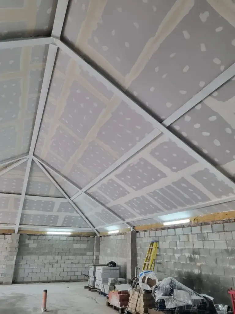 Interior blockwork and ceiling installation nearing completion.