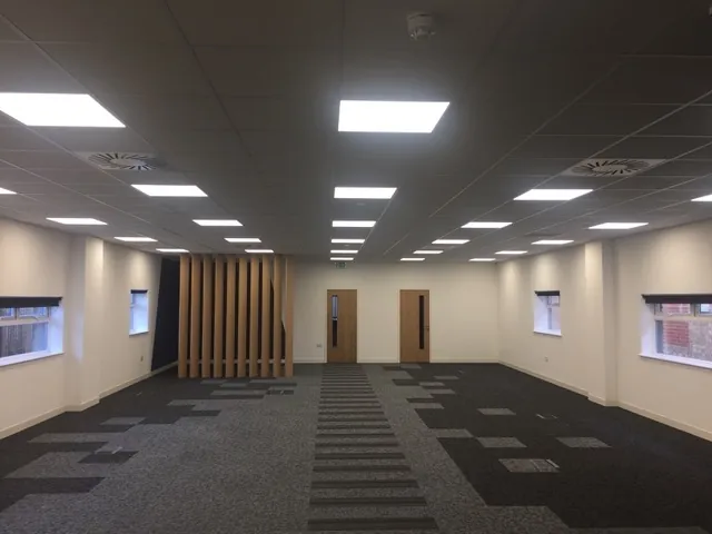 Suspended ceiling grid with tiles and recessed lighting in a Poole office